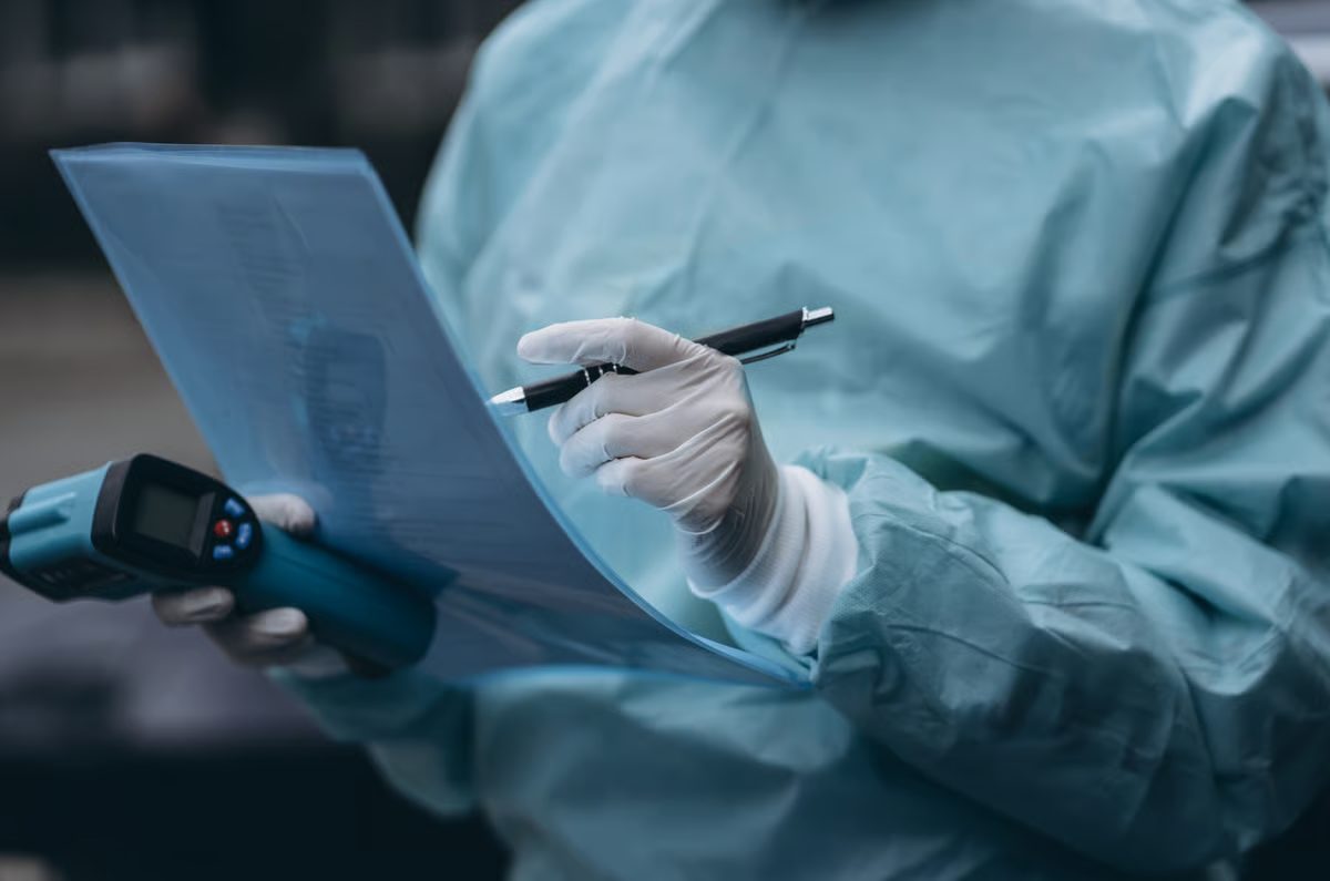 Surgeon in scrubs reviewing case notes
